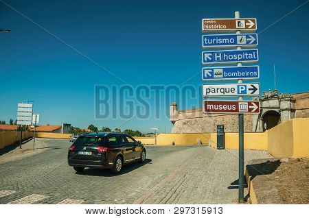 Elvas, Portugal - July 07, 2018. Car in street with signpost indicating public services and city attractions at Elvas. A gracious star-shaped fortress city on the easternmost frontier of Portugal.