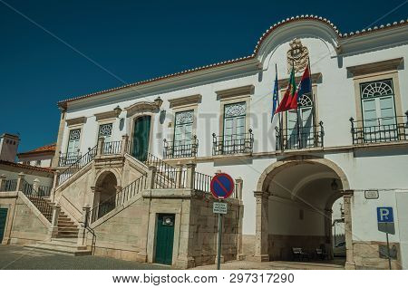 Campo Maior, Portugal - July 8, 2018. City Hall Building With Passageway Under Arch And Flags At Cam