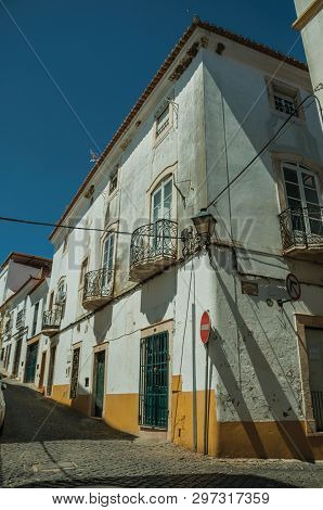 Campo Maior, Portugal - July 8, 2018. Old Colorful Houses With Cracked Plaster And No Entry Road Sig