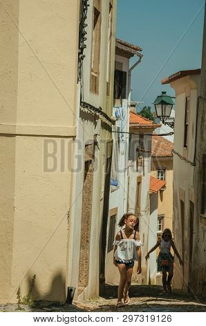Castelo De Vide, Portugal - July 10, 2018. Two Little Girls Walking Up The Alley Among Old Houses At