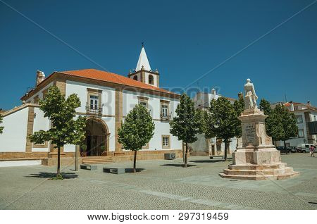 Castelo De Vide, Portugal - July 10, 2018. Houses And Steeple In Baroque Style On Square With Statue