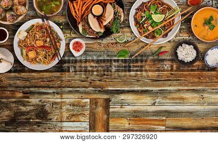 Asian food background with various ingredients on rustic wooden table , top view. Vietnam and Thai cuisine.