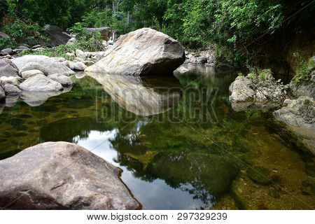 Rock Reflection On River