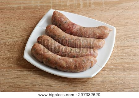 Raw Meat Sausages Kupaty In White Plate On Wooden Background
