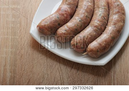 Raw Meat Sausages Kupaty In White Plate On Wooden Background