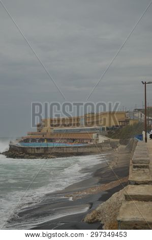 Pool Of A Hotel At The End Of The Photo On A Cloudy Day At Playa Grande In Colares. Nature, Architec