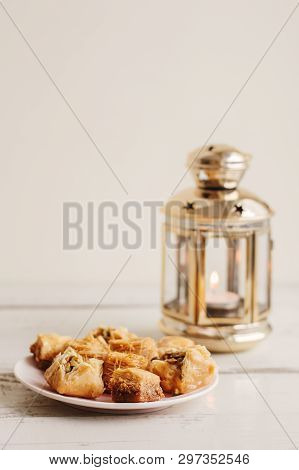 Traditional Arabic Baklawa And Gold Colored Metal Lanterm On Wooden Table. Festive Atmosphere
