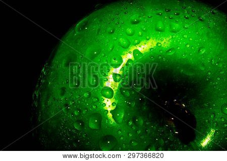 Green Ripe Apple With Water Droplets On A Dark Background, Closeup