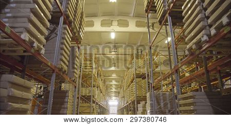 A Large Warehouse With Products From The Dcs. Large Storage Shelves. Warehouse Of Wooden Products.