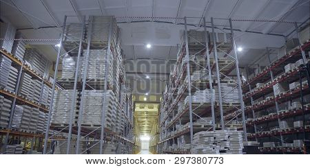 A Large Warehouse With Products From The Dcs. Large Storage Shelves. Warehouse Of Wooden Products.