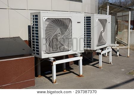 Industrial Air Conditioner Condensers (outdoor Unit) On The Ground Near The Building On A Hot Summer