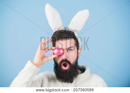 Funny Bunny With Beard And Mustache Hold Pink Egg. Bearded Man Wear Silly Bunny Ears. Easter Symbol 