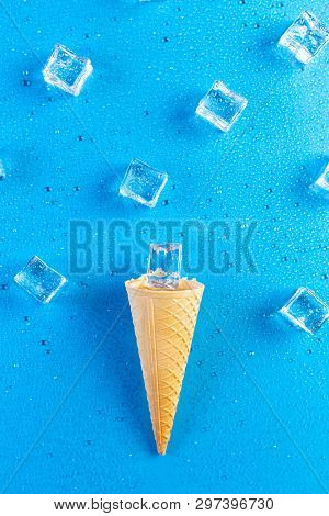 Ice Cream Cone With Ice Cubes Melted On Blue Background