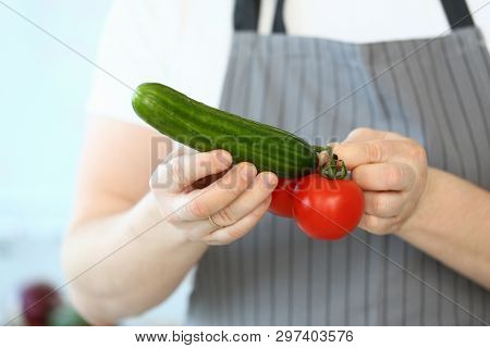 Chef Hands Showing Humorous Vegetable Phalos. Comic Male Joking With Tomato And Cucumber. Man Holdin