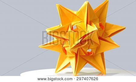 Stellated Dodecahedron Origami On Grey Background. Large Yellow Star Paper Figurine. Paper Artwork F