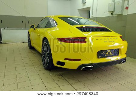 Moscow, Russia - April 14, 2019: Porsche 911 Carrera Wrapped In Bright Yellow Film, Service And Deta