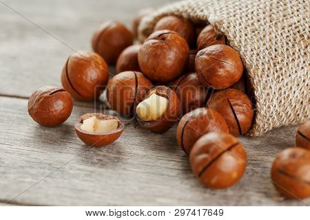 Macadamia Nut On A Wooden Table In A Bag, Closeup, Top View