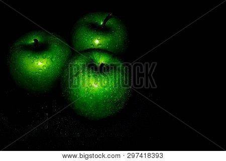 Green Ripe Apple With Water Droplets On A Dark Background, Closeup