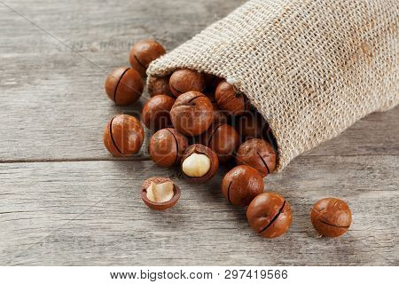 Macadamia Nut On A Wooden Table In A Bag, Closeup, Top View