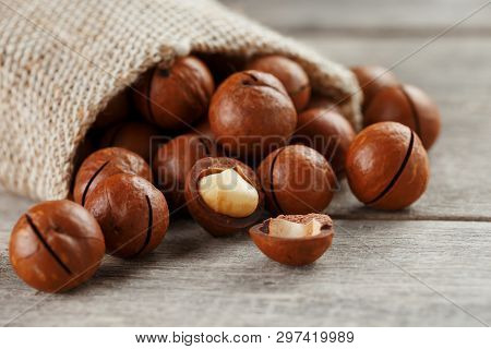 Macadamia Nut On A Wooden Table In A Bag, Closeup, Top View