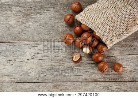 Macadamia Nut On A Wooden Table In A Bag, Closeup, Top View