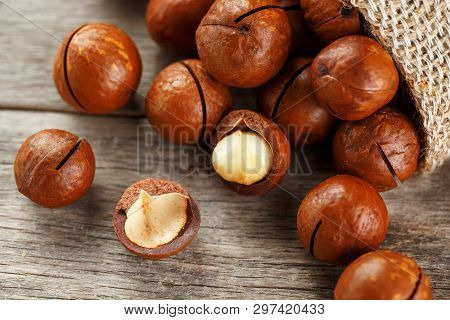 Macadamia Nut On A Wooden Table In A Bag, Closeup, Top View