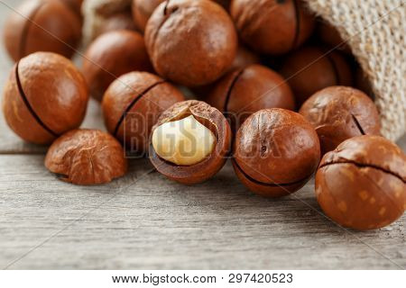 Macadamia Nut On A Wooden Table In A Bag, Closeup, Top View