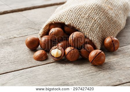 Macadamia Nut On A Wooden Table In A Bag, Closeup, Top View