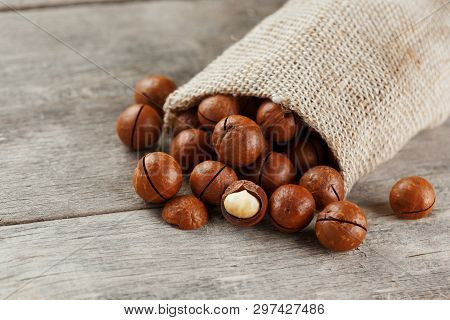 Macadamia Nut On A Wooden Table In A Bag, Closeup, Top View
