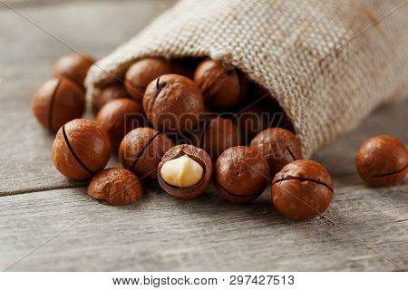 Macadamia Nut On A Wooden Table In A Bag, Closeup, Top View
