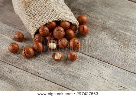 Macadamia Nut On A Wooden Table In A Bag, Closeup, Top View