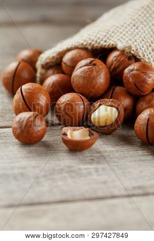 Macadamia Nut On A Wooden Table In A Bag, Closeup, Top View