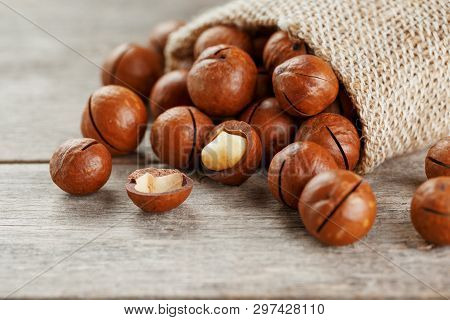 Macadamia Nut On A Wooden Table In A Bag, Closeup, Top View