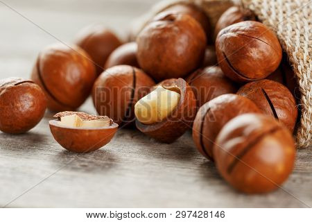 Macadamia Nut On A Wooden Table In A Bag, Closeup, Top View