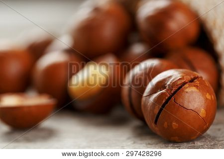 Macadamia Nut On A Wooden Table In A Bag, Closeup, Top View