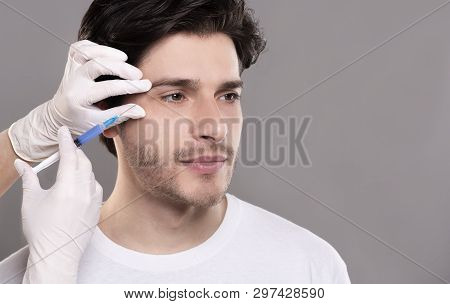 Beauty Injection For Men. Millennial Guy Getting Surgery Filling Of Facial Wrinkles, Empty Space