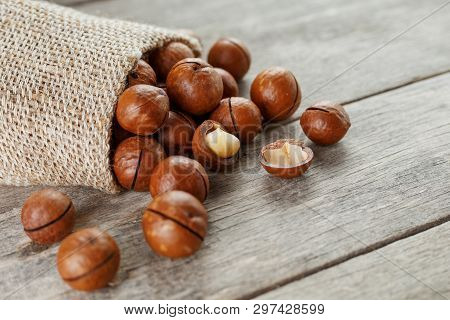 Macadamia Nut On A Wooden Table In A Bag, Closeup, Top View