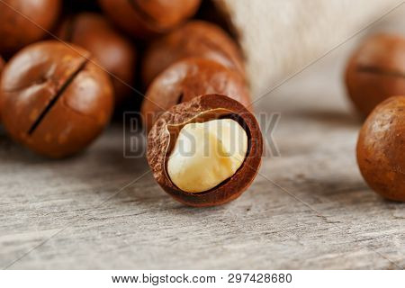 Macadamia Nut On A Wooden Table In A Bag, Closeup, Top View
