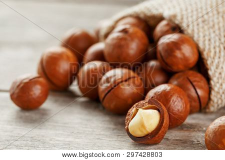Macadamia Nut On A Wooden Table In A Bag, Closeup, Top View