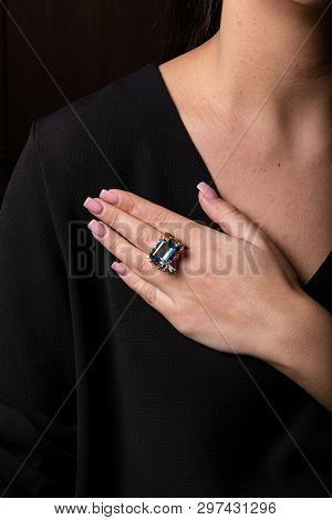 Womens Gold Ring Wth Diamonds And Blue Big Stone In The Form Of Square In The Middle On The Finger, 