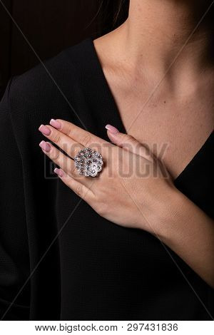 Womens Silver Ring In The Form Of A Big Flower With Diamonds On The Finger, On A Black Background.