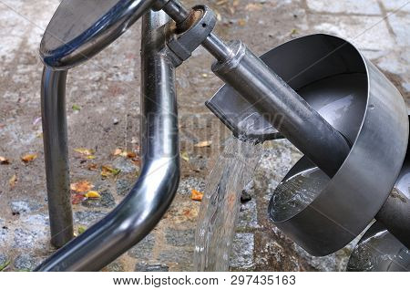Archimedean Screw At Playground Pouring Water Out Of Helical Structure