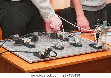 Engineers Connect Wires Control Panel With A Small Test Bench For Experiments