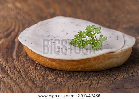 Bun On Wood With Sausage And Parsley