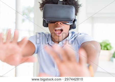 African amaerican man having fun playing with virtual reality glasses