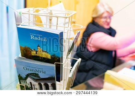 Radun Castle, Czech Republic, 7 April 2019 - A Women Selling Tickets With Guid Books In Front On Rad