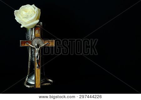 Tin Cup For Wine, Crucifix With Wooden Inlay (souvenirs From Germany) And White Rose On Black Backgr