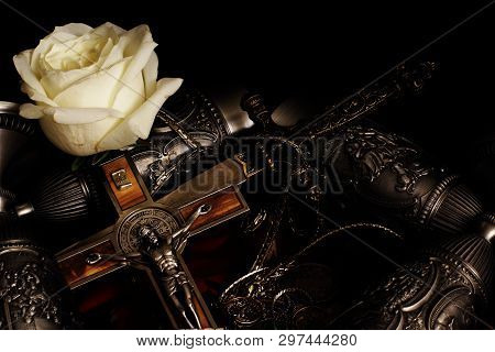 Stiletto, Crucifix With Inlaid Metal Chain, Metal Goblets For Wine And White Rose On Black Backgroun