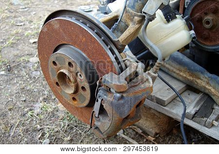 Old And Rusty Car Parts Like Brake Discs,axles And Engines.