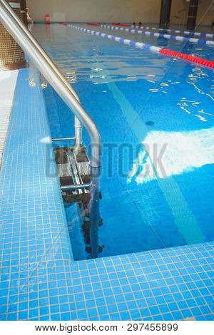 Metal Swimming Pool Steps.interior Of Sport Hall.stainless Steel Swimming Pool. Hand Rails Of Swimmi